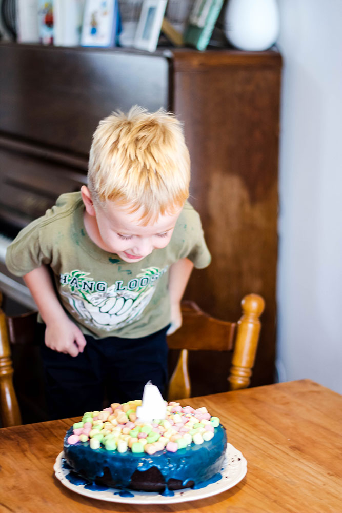4 year old blowing out candles
